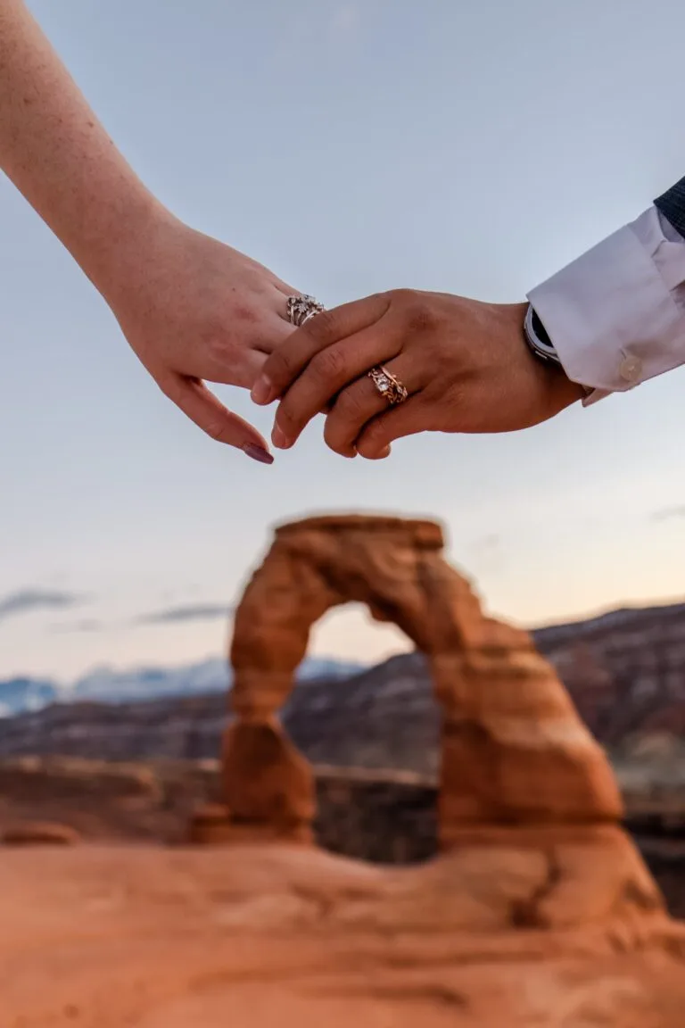 Holding hands in Arch Outdoor Wedding
